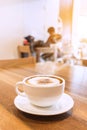 White cup of coffee with smoke on table in cafe. Royalty Free Stock Photo