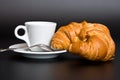 White cup coffee, spoon and croissant