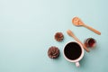 White cup coffee and sugar in spoon wood on light blue background