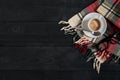 White cup of the coffee and vintage scarf on black wooden background Royalty Free Stock Photo
