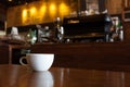 White cup of coffee on wooden bar in Coffee shop blur background Royalty Free Stock Photo