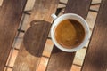 White cup of coffee on wooden table