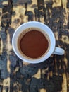 white cup with double espresso on a charred wood plank background Royalty Free Stock Photo