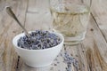 A white cup of dried lavender with stainless tea spoon Royalty Free Stock Photo