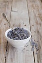 A white cup of dried lavender with stainless tea spoon Royalty Free Stock Photo