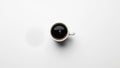 A white cup filled with black coffee is placed on a plain white surface Royalty Free Stock Photo