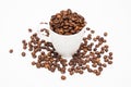 Cup filled with coffee beans with coffee beans on a white background Royalty Free Stock Photo