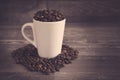 White cup filled with coffee bens Royalty Free Stock Photo