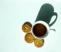 White cup filled with green tea and three biscuits from above Royalty Free Stock Photo