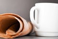 White cup and folded newspaper Royalty Free Stock Photo