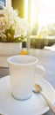 White cup of fresh espresso coffee on a table with flowers. Good morning Royalty Free Stock Photo