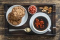 White cup of fresh morning goji coffee with cookies on wooden tray on the table, top view, close up Royalty Free Stock Photo