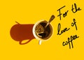 White cup of freshly brewed coffee with foamy crema tea spoon on solid yellow background top view. Hand lettering