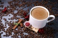 White cup full of coffee beans close up against the dark grey background. Coffee mug. Royalty Free Stock Photo