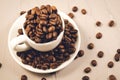 White cup full of coffee beans/white cup full of coffee beans on a concrete background. Top view Royalty Free Stock Photo