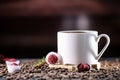 White cup full of coffee beans , red flowers and red chocolate candy against the background of a red wood wall. Royalty Free Stock Photo