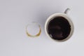 White cup full of espresso coffee, with brown circle coffee stains and drops isolated on white background, elevated top view, flat Royalty Free Stock Photo