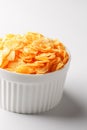 White cup with golden corn flakes isolated on white background. View from above. Delicious and healthy breakfast Royalty Free Stock Photo