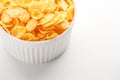 White cup with golden corn flakes isolated on white background. View from above. Delicious and healthy breakfast Royalty Free Stock Photo