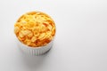 White cup with golden corn flakes isolated on white background. View from above. Delicious and healthy breakfast Royalty Free Stock Photo