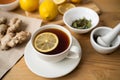 A white cup of green natural tea with ginger, lemon and honey on wooden rustic background. Royalty Free Stock Photo