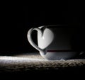 White cup with heart shadow Royalty Free Stock Photo