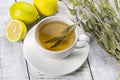 white cup of herbal sage tea with dried sage leaves and lemon on white wooden rustic background Royalty Free Stock Photo