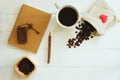 White cup of hot black coffee, brown notebook, pencil, vintage key, coffee bean decorated on white table background, copy space, Royalty Free Stock Photo