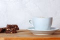 White cup of hot cocoa with marshmallows and some pieces of chocolate with nuts and raisin on wooden background. Royalty Free Stock Photo