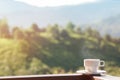 White cup of hot coffee on balcony with natural and mountains. Royalty Free Stock Photo