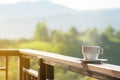 White cup of hot coffee on balcony with natural and mountains. Royalty Free Stock Photo