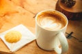 White cup of hot coffee with cookie in coffee shop Royalty Free Stock Photo