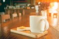 White cup of hot coffee with cookie in coffee shop Royalty Free Stock Photo