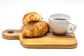 A white cup of hot coffee with croissant on wooden tray isolate on white background Royalty Free Stock Photo