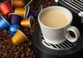 White cup with hot coffee from espresso machine pods on beans background Royalty Free Stock Photo