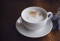 White cup of hot coffee latte on wooden table background. Top view coffee on table with dark light in afternoon Royalty Free Stock Photo