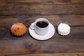 White cup of hot coffee and white marshmallows and cupcakes Royalty Free Stock Photo