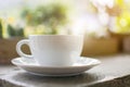 A white cup of hot drink with steaming on the wooden table Royalty Free Stock Photo