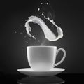 White cup with hot liquid and milk splash on black Royalty Free Stock Photo