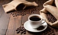 White Cup Of Hot Steamy Coffee On Old Weathered Table With Burlap Sack And Beans Royalty Free Stock Photo