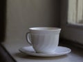 White cup is located on a windowsill Royalty Free Stock Photo