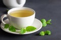 White cup of melissa herbal tea with fresh melissa leaf Royalty Free Stock Photo