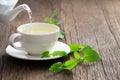 White cup of melissa herbal tea with fresh melissa leaf Royalty Free Stock Photo