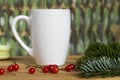White Cup mock up with berries and pine needles on a colored background