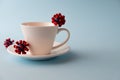 White cup with models of covid-19 virus on blue background. Epidemic coronavirus. Risk of infection COVID-19 concept.