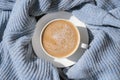 White cup of morning coffee on blue sweater background. Cozy home autumn concept. Aesthetics blog lifestyle. Still life