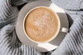 White cup of morning coffee on blue sweater background. Cozy home autumn concept. Aesthetics blog lifestyle. Still life