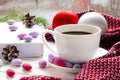 White cup of morning coffee on red warm scarf background. Cozy home concept. Aesthetics blog lifestyle.