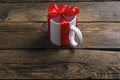 White cup mug with red ribbon bow gift Royalty Free Stock Photo