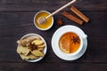 White Cup with natural herbal tea ginger lemon and honey cinnamon. Energy vitamin drink is used for colds.Dark wooden background Royalty Free Stock Photo